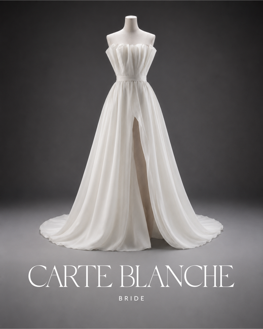 Strapless ivory wedding dress with a pleated bodice and flowing skirt on a mannequin for a blog about finding your perfect wedding dress.