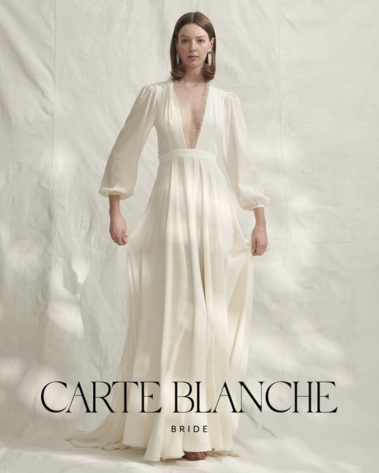 Bride in Donatelle Godart Dance With Me wedding gown with flowing full skirt and soft draped sleeves