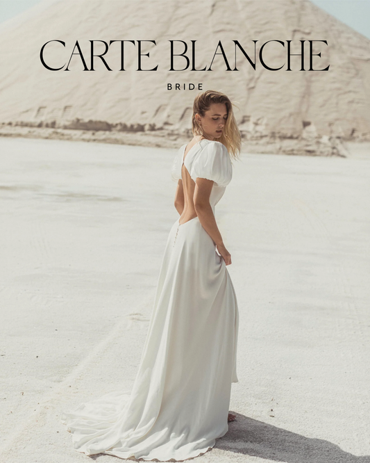 A bride wearing a Caroline Takvorian French lace wedding dress looking effortless and modern, representing the authentic bridal style at Carte Blanche Bride.