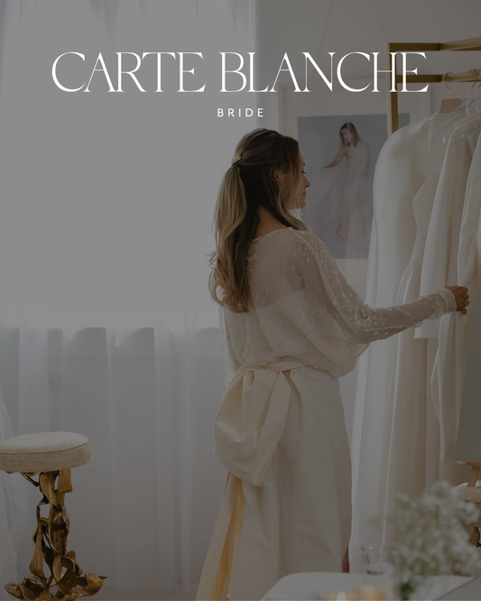 A bride wearing a fluid, natural-fiber wedding gown browsing the exclusive Cortana Spain bridal collection at Carte Blanche Bride Melbourne.