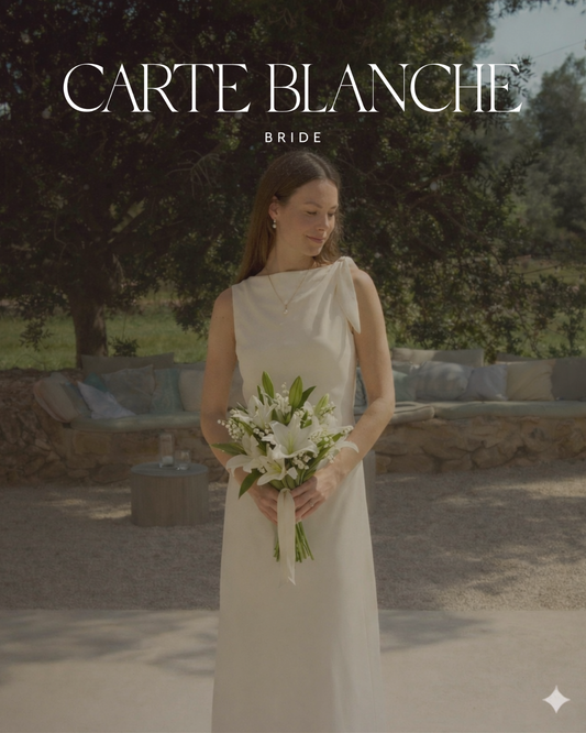 A modern minimalist bride wearing a luxury made-to-order silk wedding gown for an intimate celebration.