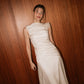 Front view of the asymmetric ruched top and column skirt from the Bella Set by The Muse Collective.