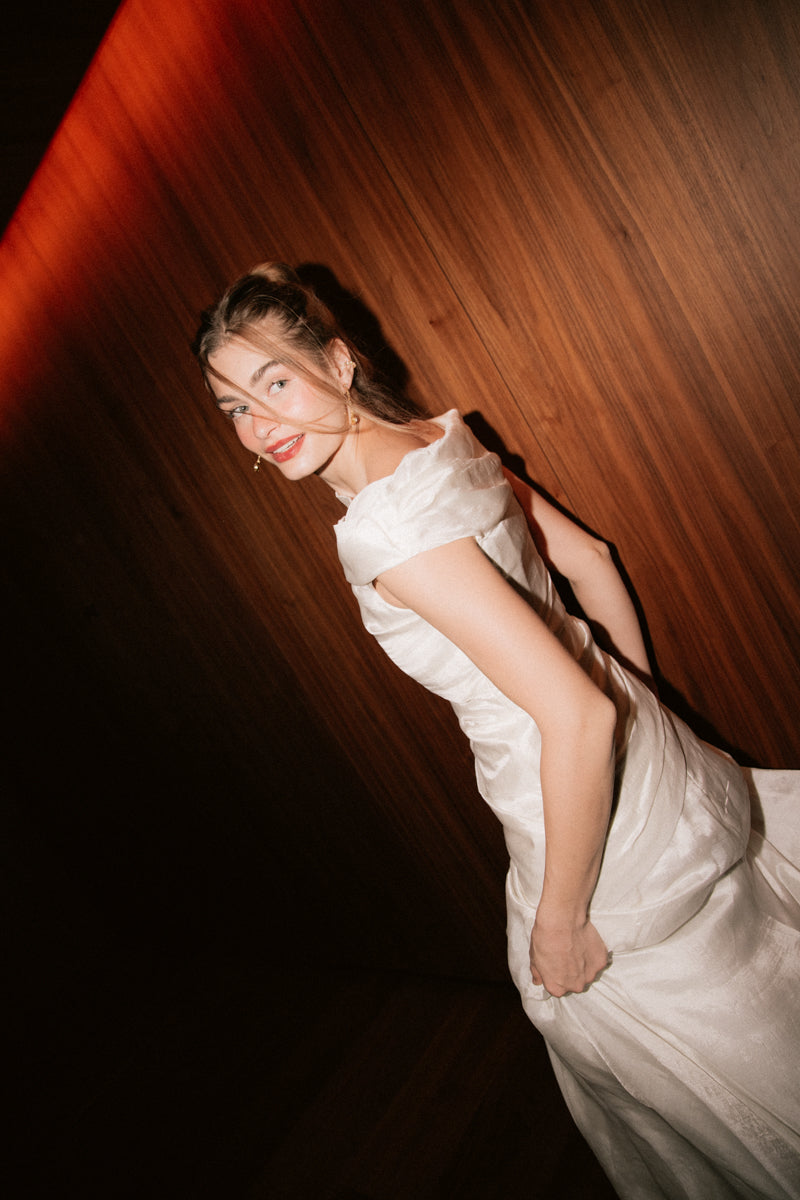 Side angle of the off-shoulder Bella Set silk bridal top and skirt by The Muse Collective, available at Carte Blanche Bride.