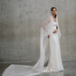 Full-length view of the Clara silk gown paired with a long cathedral-length lace-edged veil extending behind.