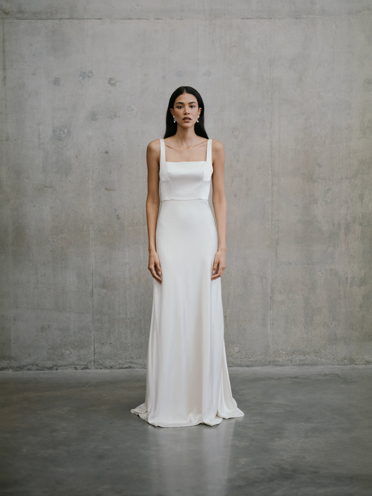 Full-length front view of the Unbridled Studio Clara silk gown with a square neckline and sleek column skirt at Carte Blanche Bride Australia.