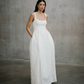 Full length portrait of the Unbridled Studio Thora gown featuring a pleated A-line skirt and relaxed pocket detail.