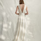 French designer silk crepe wedding gown with plunge neckline both front and back with optional belt.